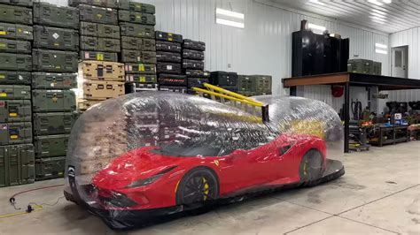 Watch A Youtuber Throw Ladders And Stuff At A Ferrari Parked In A Plastic Storage Bubble The