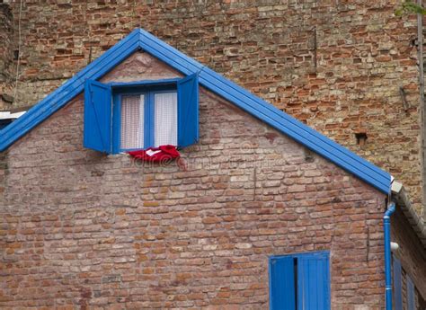 Brown Old Brick House With Wooden Window Shutters Stock Photo - Image ...