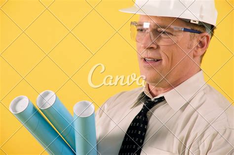 Construction Foreman Holding Blueprint Tubes Photos By Canva