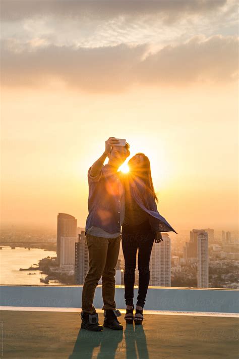 Couple Pose For A Rooftop Selfie By Stocksy Contributor Jovo