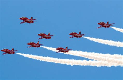 Red Arrows jets with white smoke and blue sky Photograph by Charlesy - Fine Art America