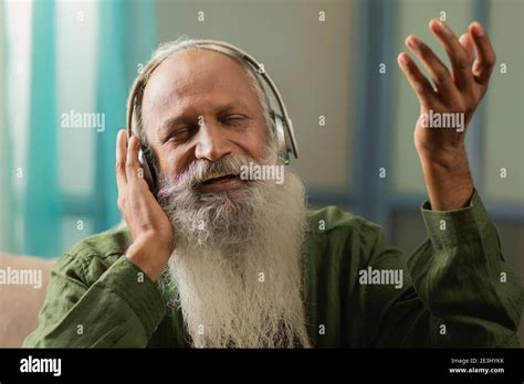 A HAPPY OLD MAN SINGING ALONG WHILE LISTENING TO MUSIC Stock Photo - Alamy