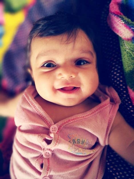 Premium Photo Portrait Of Cute Baby Girl Lying Down On Bed