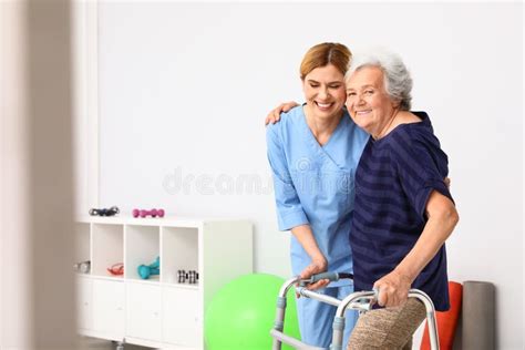 Caretaker Helping Elderly Woman with Walking Frame Stock Photo - Image of hospice, disabled ...