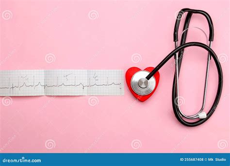 Stethoscope Red Heart And Cardiogram On A Pink Background Top View