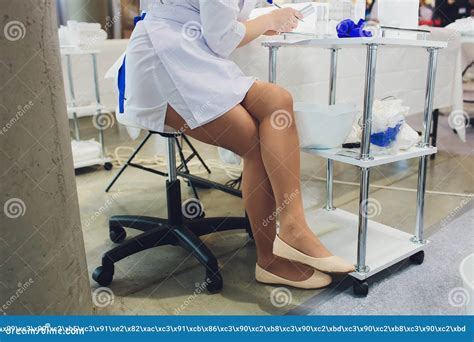 The Bottom Of The Doctor In A White Coat Sits In The Hospital Stock