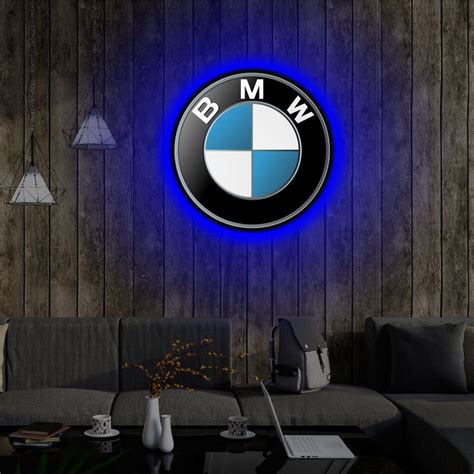 A Living Room With A Couch Table And Bmw Logo On The Wall Above It