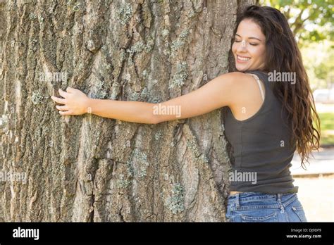 Casual Attractive Brunette Embracing A Tree With Closed Eyes Stock