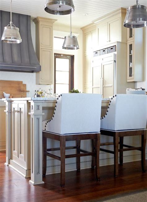 Two White Chairs Sitting In Front Of A Stove Top Oven Next To A Wooden