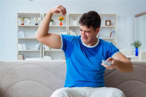 Premium Photo Man Sweating Excessively Smelling Bad At Home