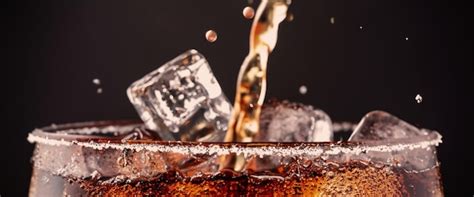 Premium Photo Pouring Of Cola And Ice Cola Soda And Ice Splashing