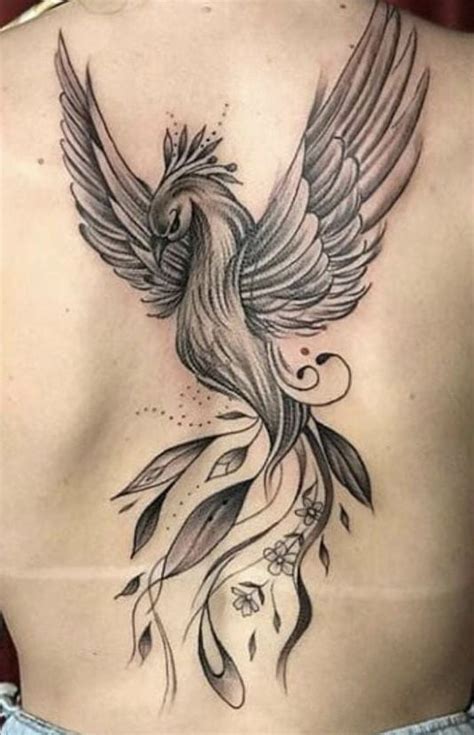 A Woman S Back With A Bird Tattoo On It