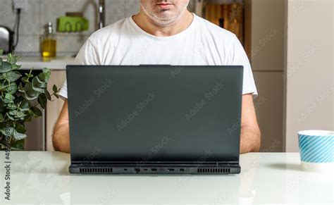 Trendy Mature Man Working From Home With Laptop Sitting At The Table In