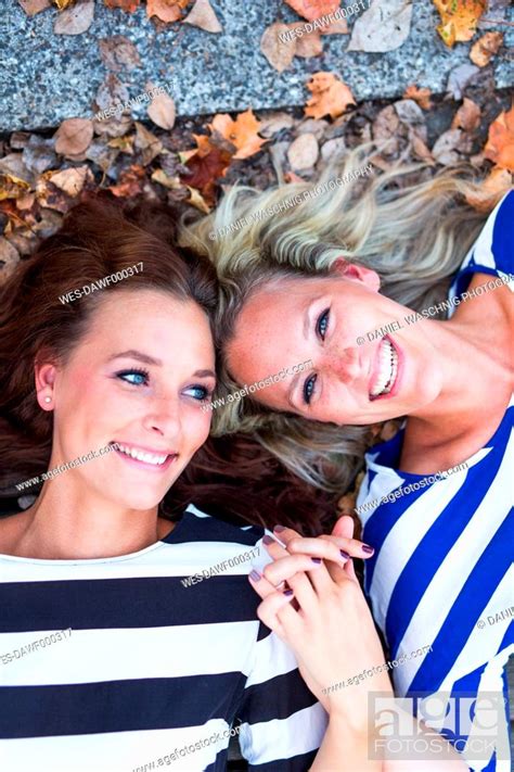 Portrait Of Smiling Lesbian Couple Holding Hands Stock Photo Picture And Royalty Free Image