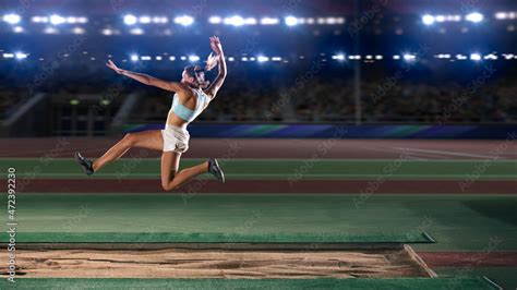 Foto De Long Jump Championship Professional Female Athlete Jumping On