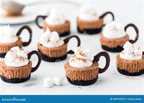 Hot Cocoa Mini Cheesecakes Topped With Whip Cream And Marshmallows
