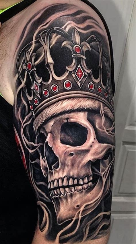 A Man With A Skull And Crown Tattoo On His Arm