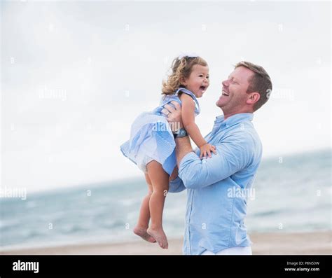 Father holding daughter Stock Photo - Alamy