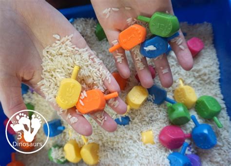 Dreidel Sensory Bin With Rice Dinosaurs