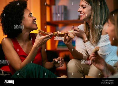 Happy Multicultural Female Friends Having Party At Home And Eating