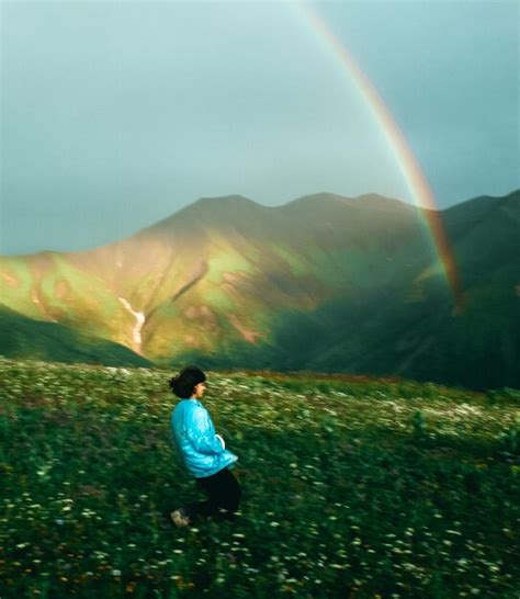 Premium Photo Rear View Of Man On Rainbow Over Land