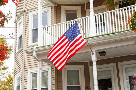 Premium Photo American Flag Proudly Waving Against A Clear Blue Sky