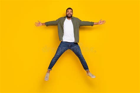 Full Length Photo Of Cute Cheerful Man Wear Khaki Shirt Jumping High