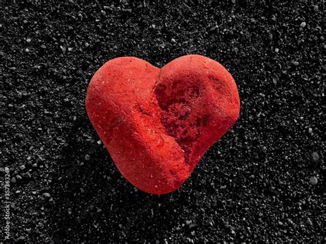 Zdjęcie Stock Red Heart Stone In Love Shape On Black Rock Background