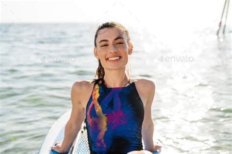 Image Of Happy Beautiful Girl In Swimsuit Smiling And Kayaking Stock