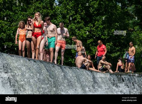 People Enjoy The Water At Warleigh Weir On The River Avon Near Bath In