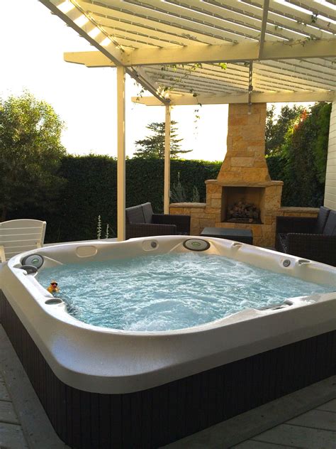 New Jacuzzi J400 series spa with fireplace in the background. | Jacuzzi ...