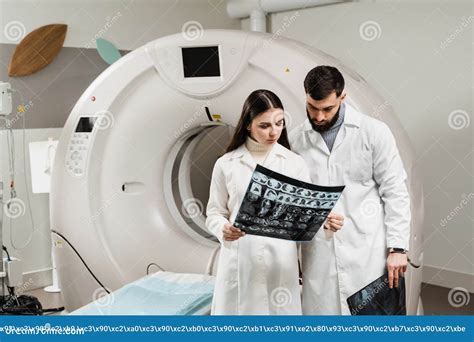 Colleague Doctors Discussing X Rays In The CT Computed Tomography Scan