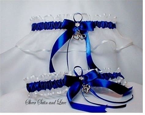 The Bridal Garter Is Adorned With Blue Satin Ribbons And Jeweled Heart