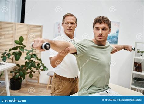 Attractive Mature Doctor Helping His Handsome Stock Photo Image Of