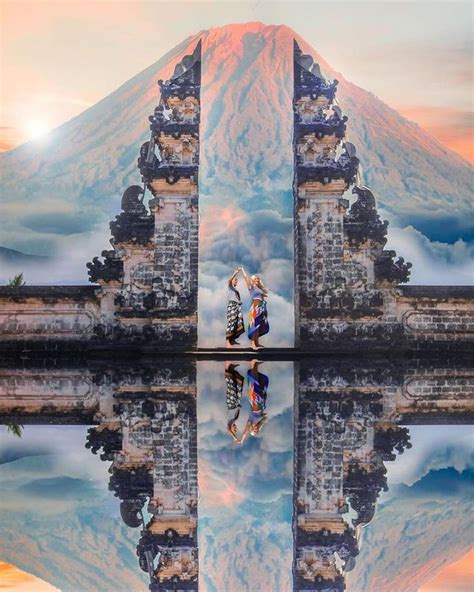 The Reflection Of Two People In Front Of A Mountain