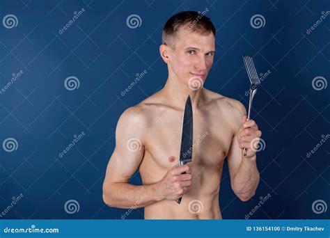 Handsome Chef With Apron On Naked Muscular Body With Knife And Kitchen Utensils Stock Photo