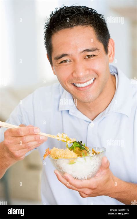 Man Enjoying Chinese Food With Chopsticks Stock Photo - Alamy