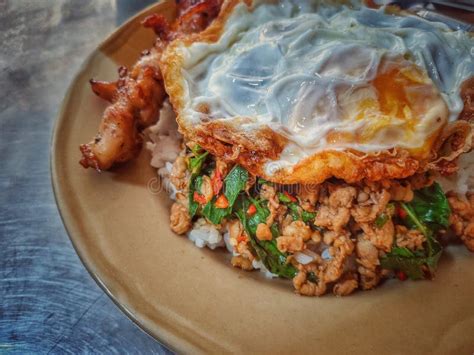 Basil Fried Rice With Minced Pork Fried Egg Grilled Chicken In A Plate On A Metal Table Stock