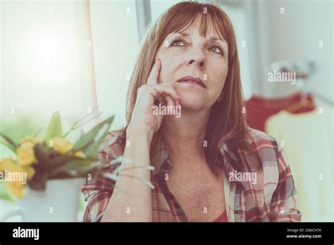 Portrait Of Pensive Mature Woman At Home Stock Photo Alamy