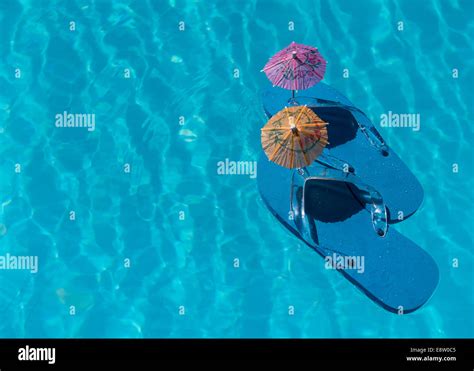 Flip Flop on pool with surface of water background Stock Photo - Alamy