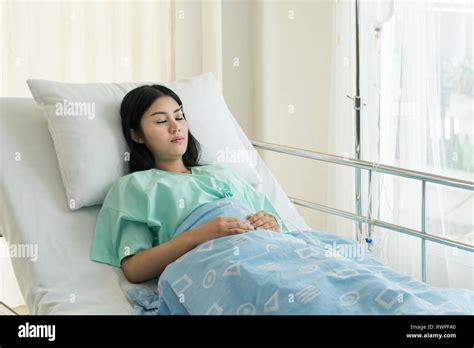 Asian Patient Woman Sleeping And Lying On Her Bed While Receiving In