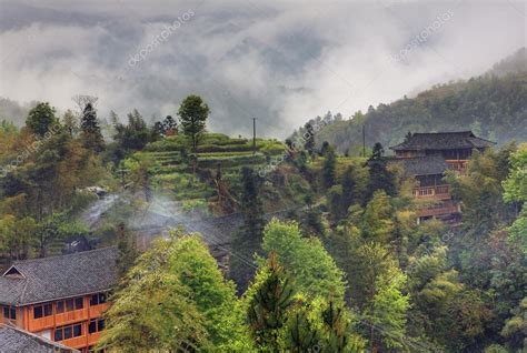 Rural landscape in the highlands of China, farmhouses ethnic village — Stock Photo © grigvovan ...