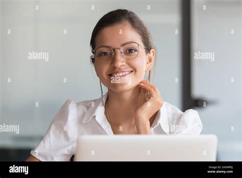 Smiling Young Business Woman Wearing Glasses Posing At Workplace Stock