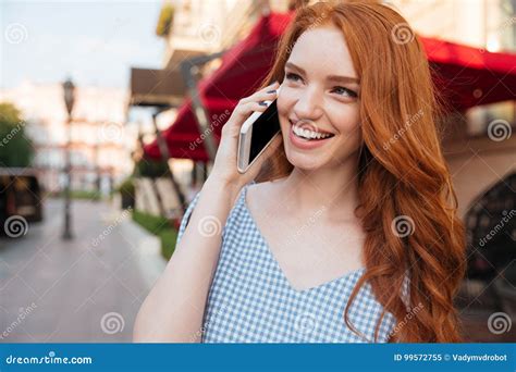 Smiling Attractive Girl With Long Hair Talking On Mobile Phone Stock