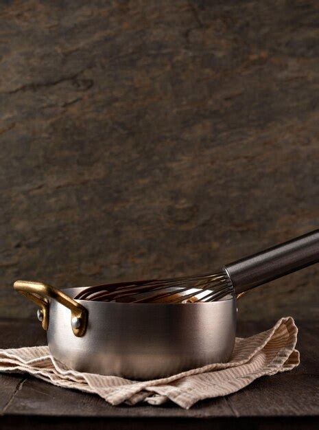Premium Photo Liquid Chocolate Cream Pouring From A Whisk Into A Ladle