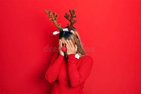 Beautiful Hispanic Woman Wearing Deer Christmas Hat And Red Nose With