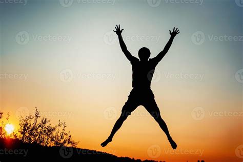 Happy Man Jumping For Joy At Sunset Success And Happiness Concept