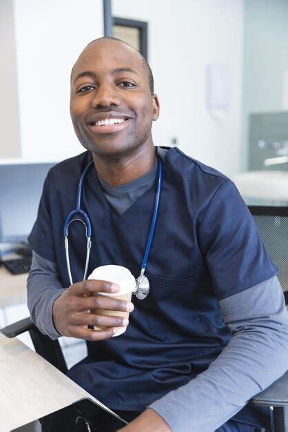 Premium Photo Portrait Of Happy African American Male Doctor Holding