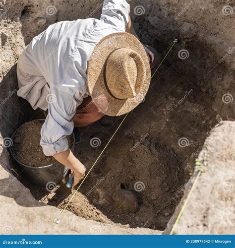 Archaeology - Archaeologist Digging Up Ancient Pottery Stock Photo