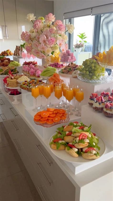 A Buffet Table Filled With Lots Of Different Foods And Drinks On Top Of